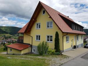 a yellow house with a red roof at Ferienhaus Seefried in Baiersbronn