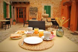 a table with plates of food and drinks on it at PETIT HOTEL ALGAIDA in Algaida