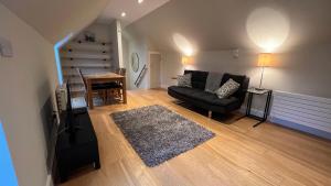 a living room with a couch and a table at NEW 1BD Contemporary Flat Upper Dunblane in Dunblane