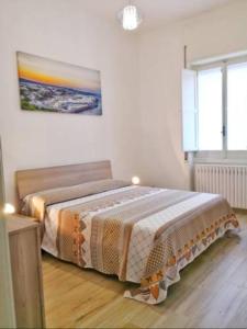 a bedroom with a bed and a painting on the wall at Casa Vergara Piazza Mazzini in Lecce