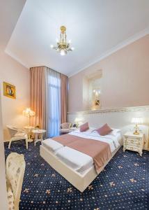 a hotel room with a large bed and a table at Vintage Hotel in Tbilisi City