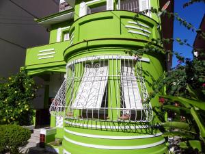 a green building with a bird cage in front of it at POA Eco Hostel in Porto Alegre +112 photos