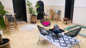 a room with two chairs and a table and chairs at Riad Dialna in Marrakesh