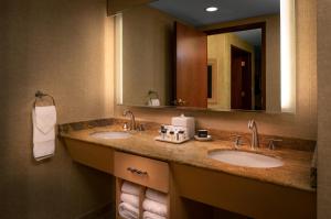a bathroom with two sinks and a large mirror at Seneca Niagara Resort & Casino in Niagara Falls