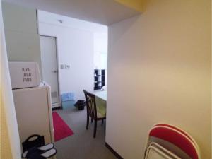 a room with a kitchen and a table with a refrigerator at T-Port - Vacation STAY 12338 in Toyama