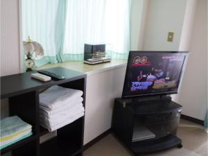a room with a television and a desk with towels at T-Port - Vacation STAY 12338 in Toyama