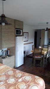 a kitchen with a white refrigerator and a table at Cėntrico PARQUE CÍVICO in Mendoza