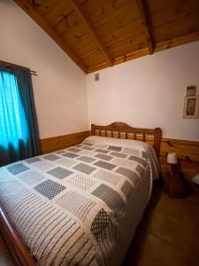 a bedroom with a large bed in a room at CABAÑAS MANOLO in San Carlos de Bariloche