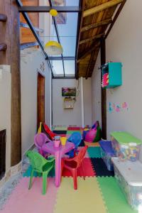 a room with colorful chairs and a table in a room at Pousada Chalés do Julião in Ubatuba