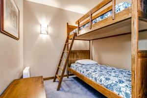 a bedroom with two bunk beds and a desk at Powderhorn Lodge 107: Columbine Suite in Solitude +45 photos