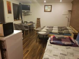 a room with two beds and a table and a dining room at PRIVAT FAMILY MALA FATRA in Chmelince