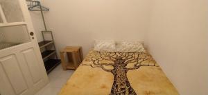 a bedroom with a bed with a tree on it at Samara's Home in Mindelo