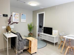 a living room with a couch and a tv at Apartamentos Martalia Namar centro in Ronda