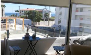 a balcony with a table and a view of the ocean at Departamento La Serena in La Serena