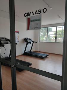 a gym with a treadmill and a phone in a room at Comfortable apartment in Bucaramanga 903 in Bucaramanga