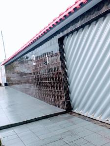 a large metal garage door with a tile floor at RESIDENCIAL OLIVEIRA in Manaus