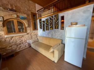 a living room with a couch and a refrigerator at Casa Nikolou Halki in Halki