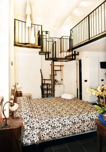 a bedroom with a bed and a spiral staircase at Affittacamere Monterosso 5 Terre in Monterosso al Mare
