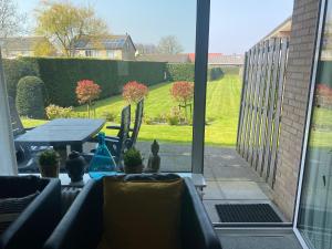 an open door to a patio with a table and chairs at Appartement Walvis nr. 9D in Vrouwenpolder