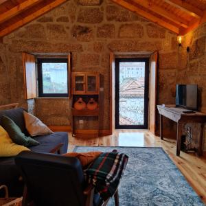 a living room with a couch and a window at Casa da Cantareira in Loriga