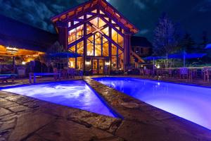 a swimming pool in front of a house at night at Mountain Lodge Telluride in Telluride