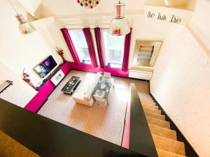 an overhead view of a living room with pink accents at PHOENIX Apartments in Goole