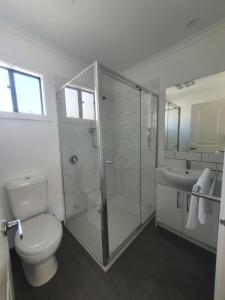 a bathroom with a toilet, sink, and shower at Anchor Belle Holiday Park in Cowes
