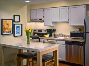 a kitchen with white cabinets and a white counter top at Sonesta ES Suites Burlington in Burlington