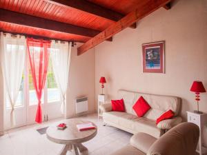 a living room with a couch and a table at Elegant holiday home near Les Eyzies de Tayac in Meyrals