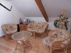 a living room with three chairs and a table at Sunny holiday home with private garden in Le Haut-du-Them