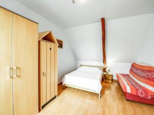 a small bedroom with a bed and a cabinet at Normandy Family Retreat in Brainville