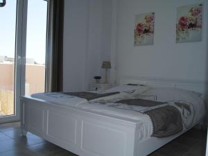 A bed or beds in a room at Villa in Loutra with Sea View and Pool