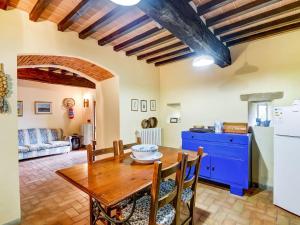 a kitchen and dining room with a wooden table and chairs at Belvilla by OYO Welcoming Holiday Home with Pool in Monterchi