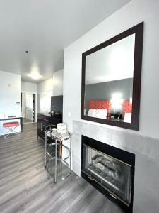 a living room with a fireplace and a mirror at Tides Inn & Suites in Port Townsend