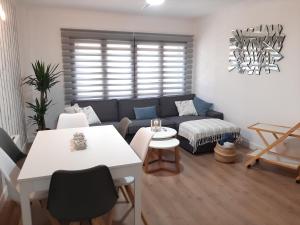 a living room with a couch and a table at Your Canary Home in Las Palmas de Gran Canaria