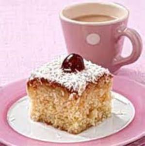 a piece of cake on a plate next to a cup of coffee at Dales View House in Barnoldswick