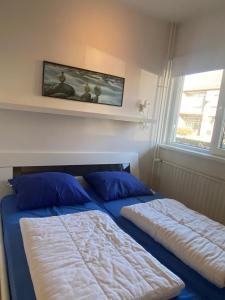 En eller flere senge i et værelse på Appartement Walvis nr. 22