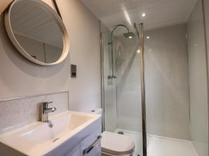 a bathroom with a sink and a shower at Ridgway Lodge in Windermere +23 photos