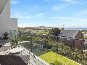 a balcony with chairs and a view of the ocean at Ocean Scene in Fingal Bay
