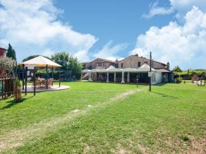 a large yard with a house and a building at Farmhouse by Lake Trasimeno with Pool in Pucciarelli +36 photos