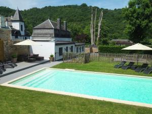 a swimming pool in the yard of a house at Stylish Mansion in Ardennes with shared Pool in Hastière-par-delà