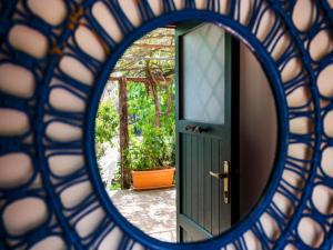 a view of a door through a mirror at Gorgeous Villa in Ricadi with Shared Garden in Ricadi