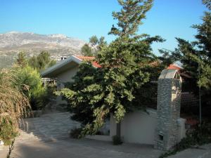 a house with a tree in front of it at Luxurious Villa in Malades Crete with Swimming Pool in Áyios Síllas