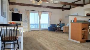 a living room with a view of the ocean at Oceanfront Penthouse with Family & Friends in Salisbury