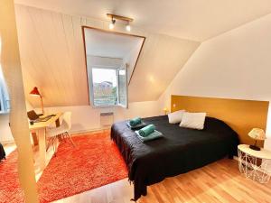 Ένα ή περισσότερα κρεβάτια σε δωμάτιο στο Charmant duplex proche de la gare, parking gratuit