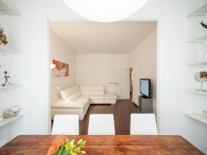 a white living room with a table and chairs at Roman Home Base in the Appio Latino in Rome