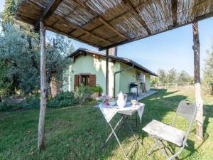 a table and chairs in a yard with a house at Blissful Tuscan Hideaway in Arezzo