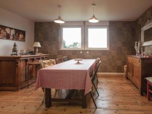 a kitchen with a table with a table cloth on it at Chalet near forest lakes and hiking trails in Raon-lʼÉtape