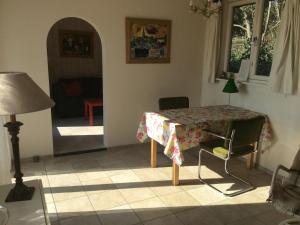 een woonkamer met een tafel en een lamp bij Comfortable Cottage by the Beach in Egmond in Rinnegom