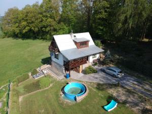 an aerial view of a house with a pool at House with the pool and fenced garden in Hnanice